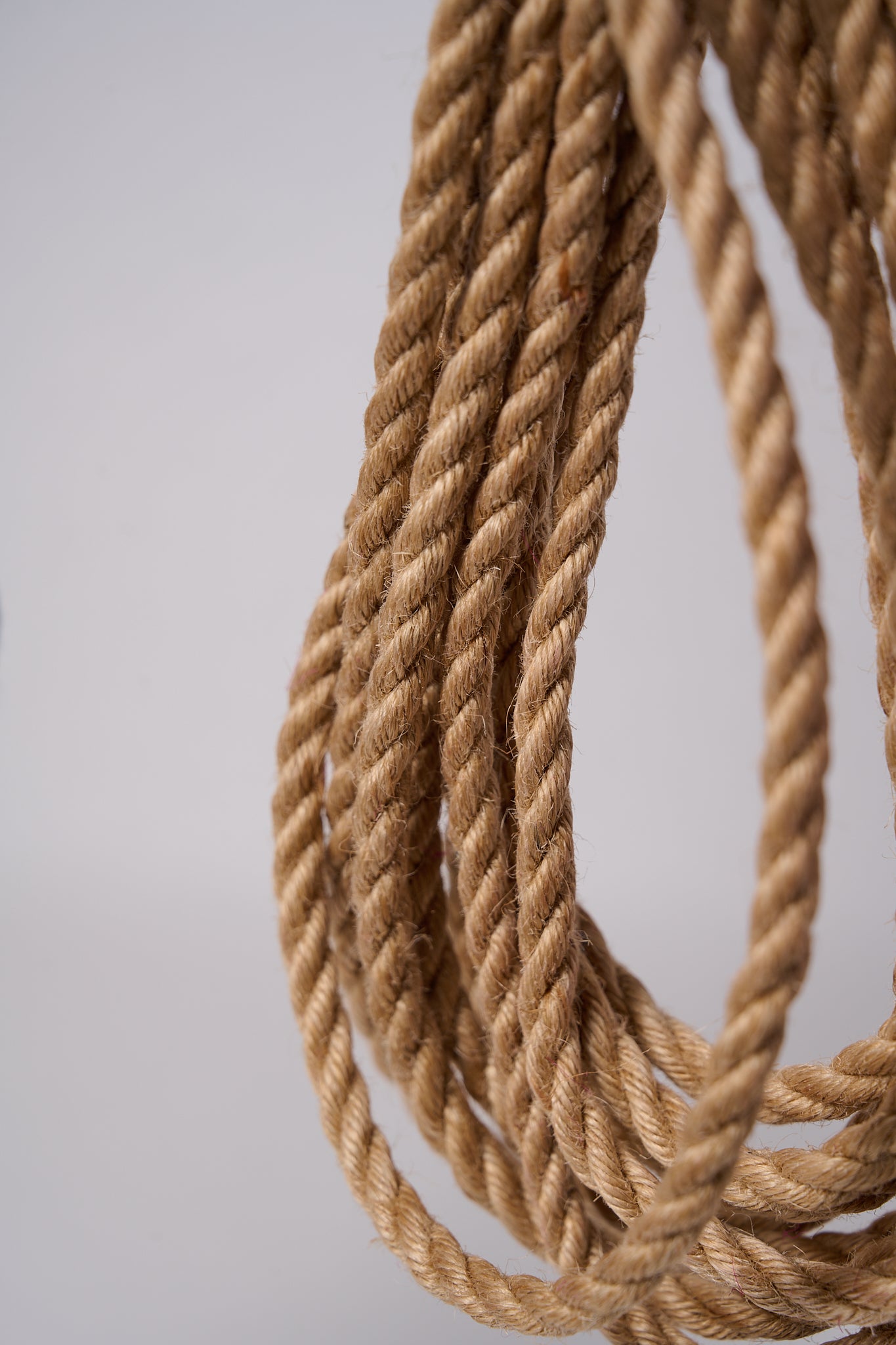 Natural Lovey Subby shibari Jute rope wrapped around and hanging.