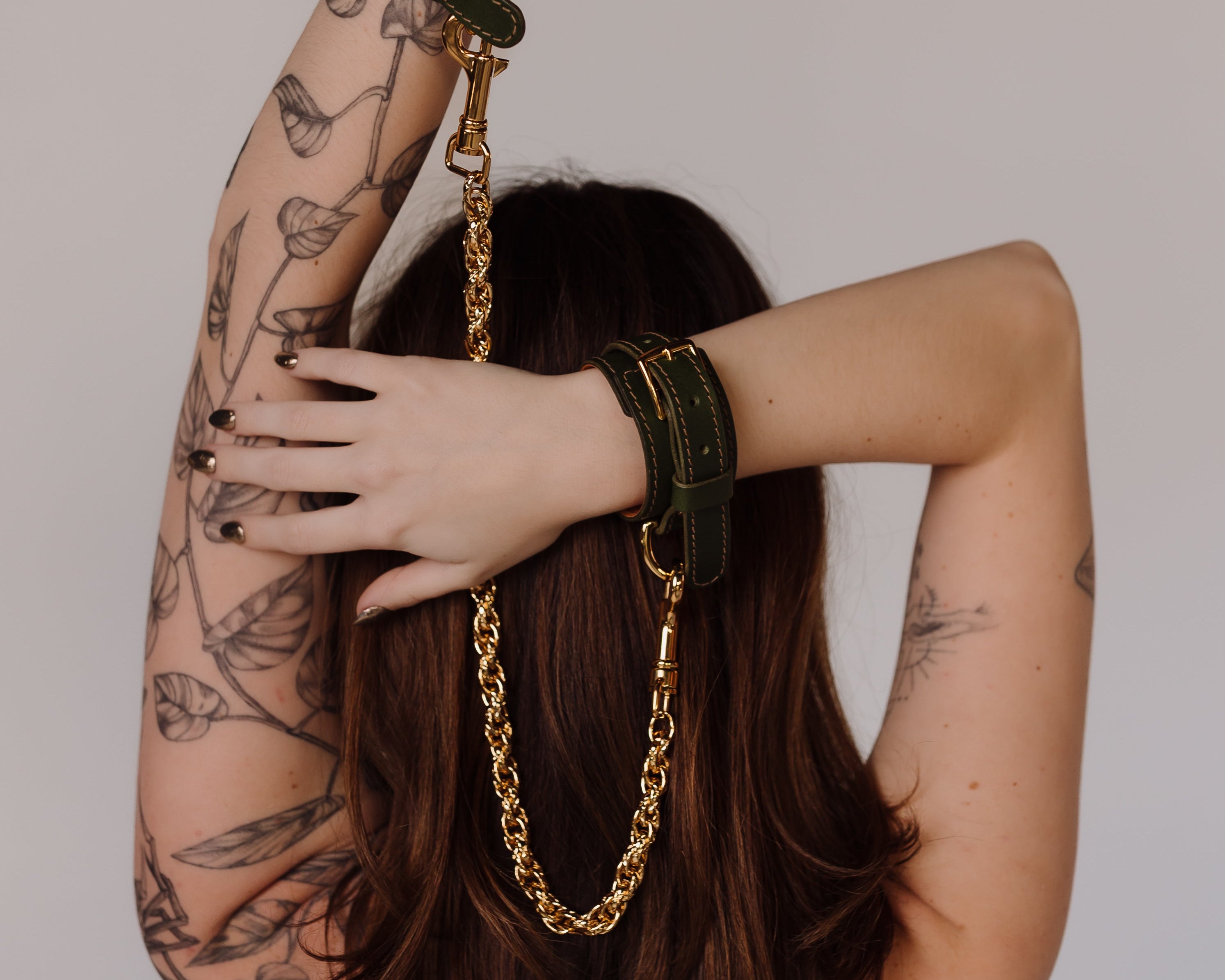 woman in leather handcuffs with chain