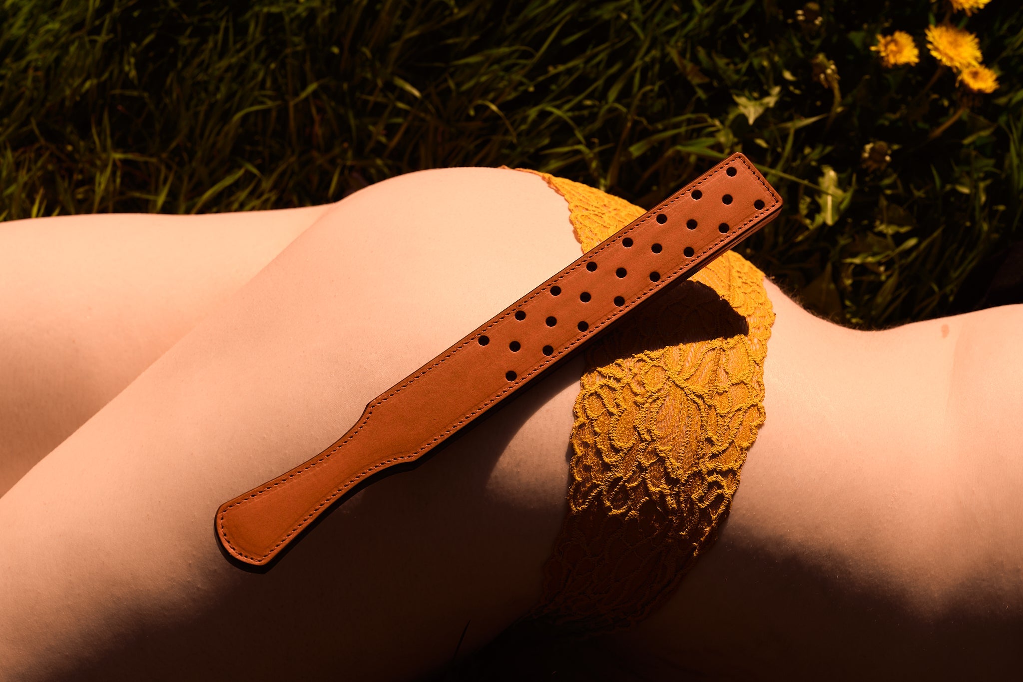woman laying on ground with dandelions with matching bottoms