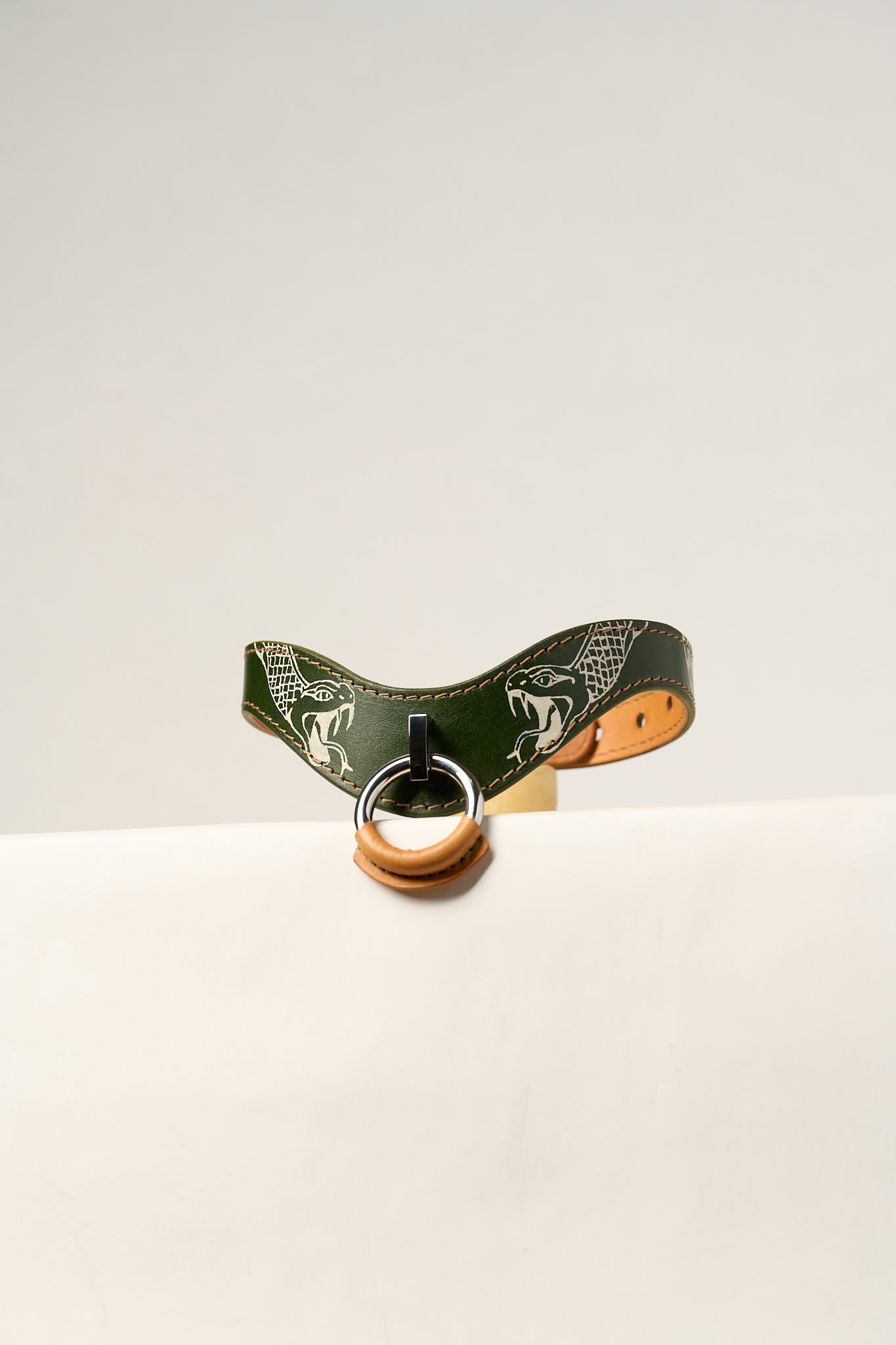 Snake tattooed green leather honeydew collar with natural leather accents and silver hardware on a white background.