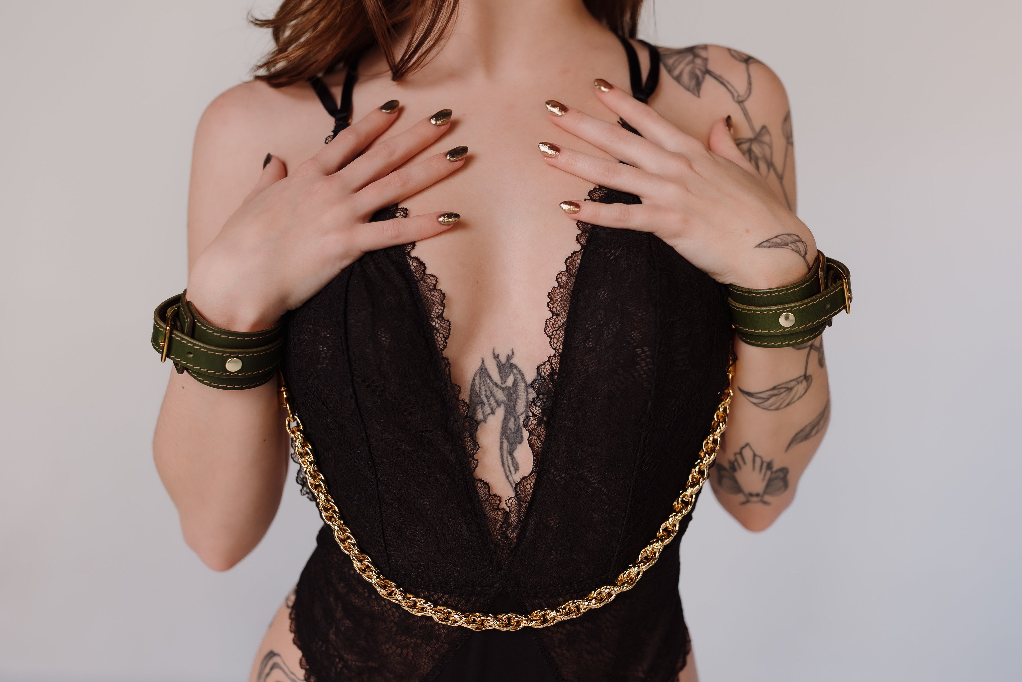 Womans with leather bracelets on in black v neck top