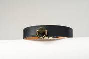 A close-up image of a luxury leather necklace with a gold stainless steel buckle, predominantly black in color.
