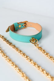 Turquoise leather luxury necklace with gold chain on a light gray background