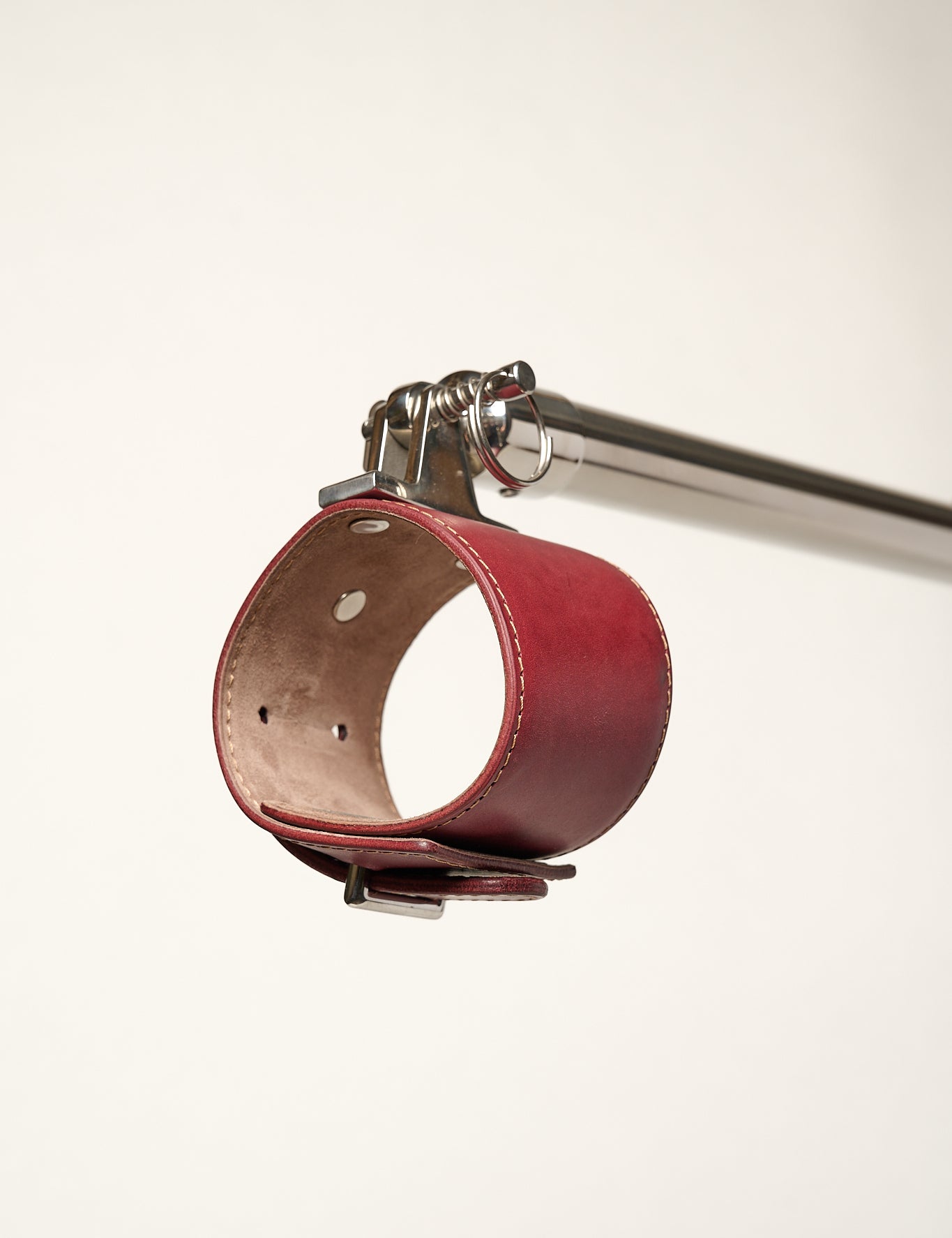 burgundy cuff attached to silver metal bar 