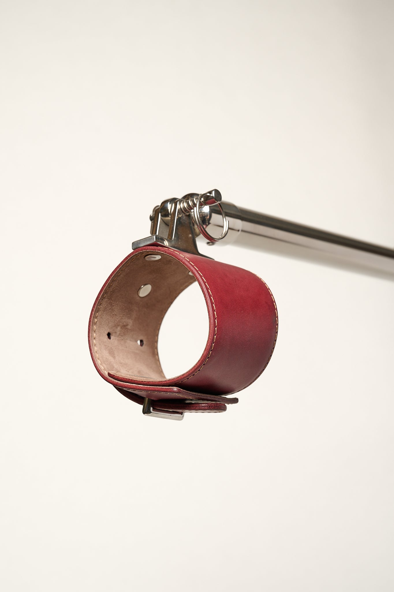 burgundy cuff attached to silver metal bar 