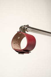 burgundy cuff attached to silver metal bar 