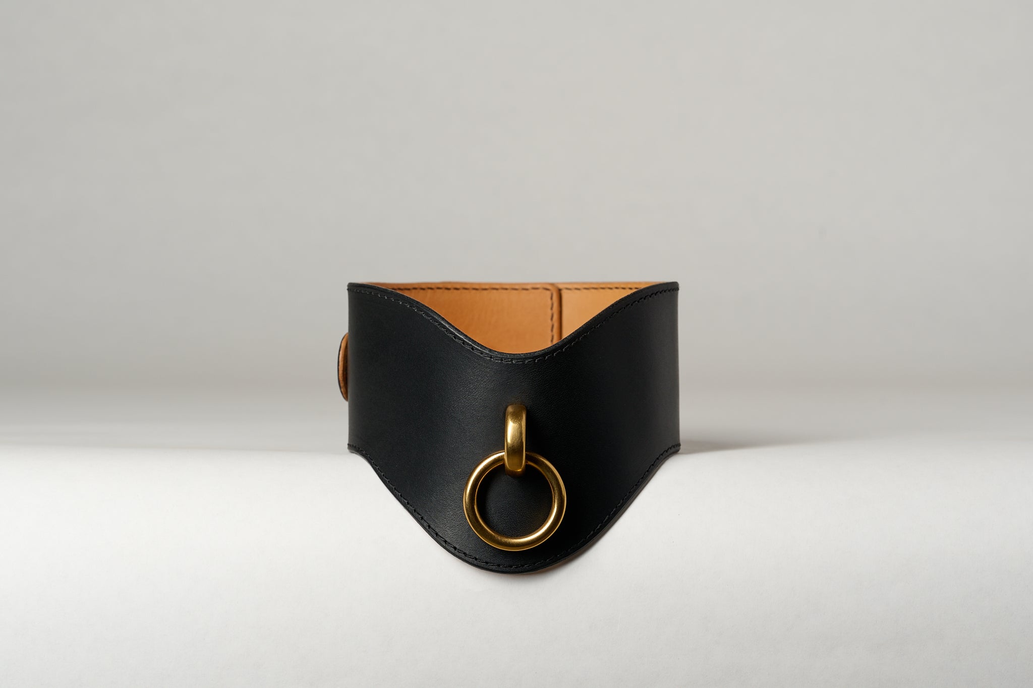 black and light brown leather wide necklace choker with gold pendant on white background