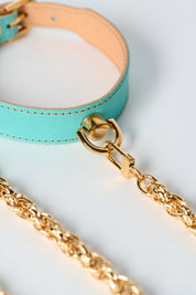 blue leather necklace with gold stainless steel chain and pendant on white background