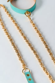 blue leather necklace with gold stainless steel chain and pendant on white background