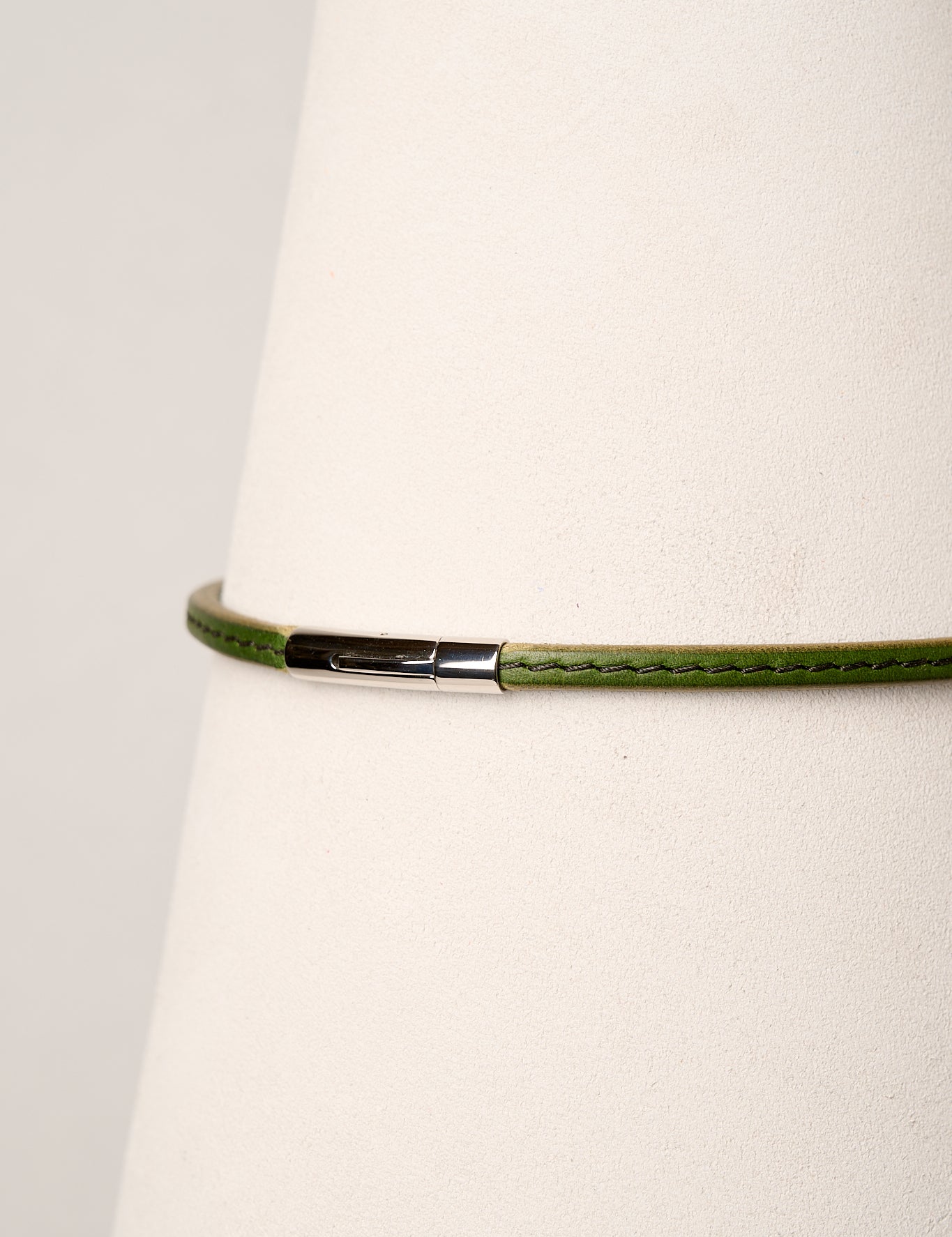 Green necklace with a silver clasp on a white background
