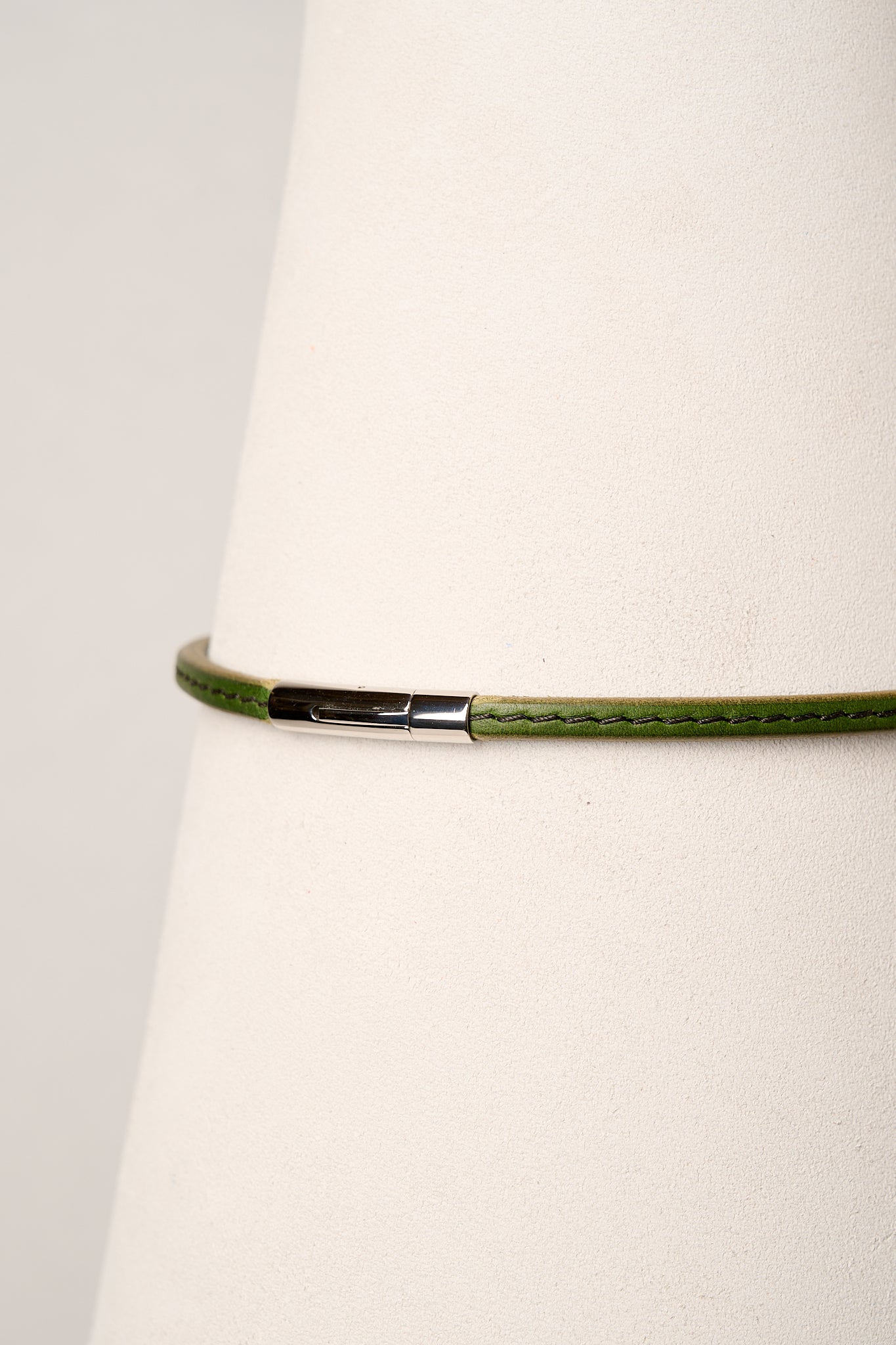 Green necklace with a silver clasp on a white background