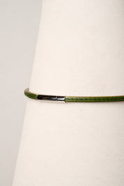 Green necklace with a silver clasp on a white background