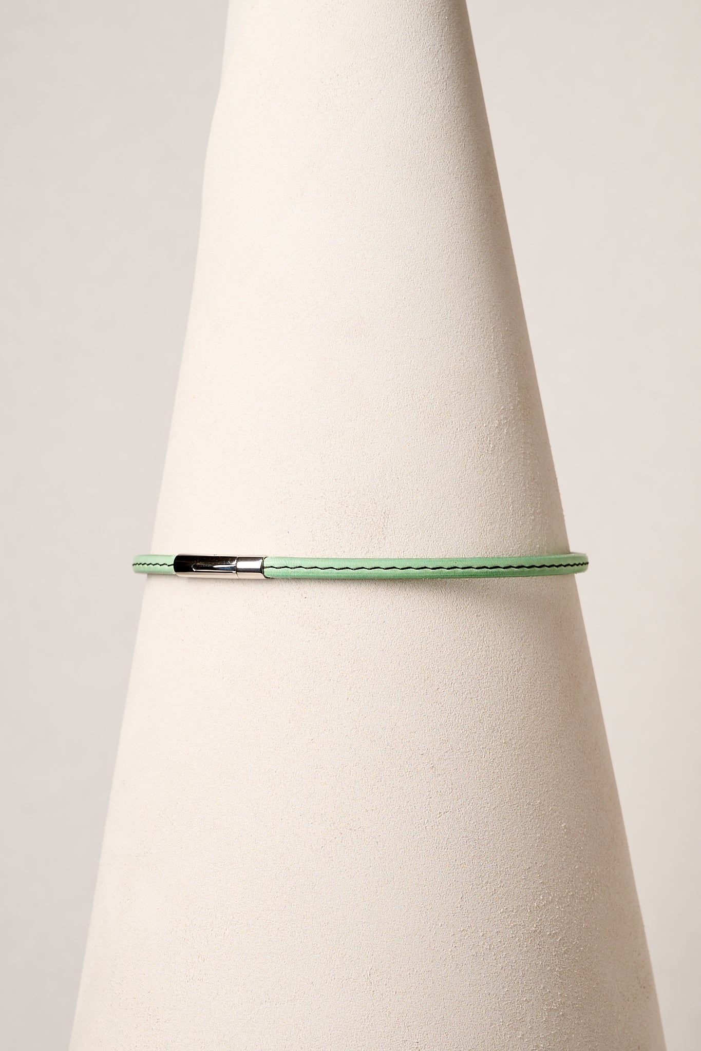Mint leather necklace with silver clasp on white background