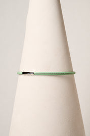 Mint leather necklace with silver clasp on white background