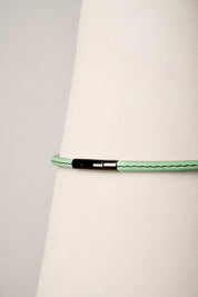mint necklace with a black clasp on a white background