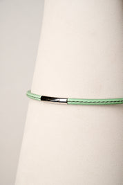 Mint leather necklace with silver clasp on white background
