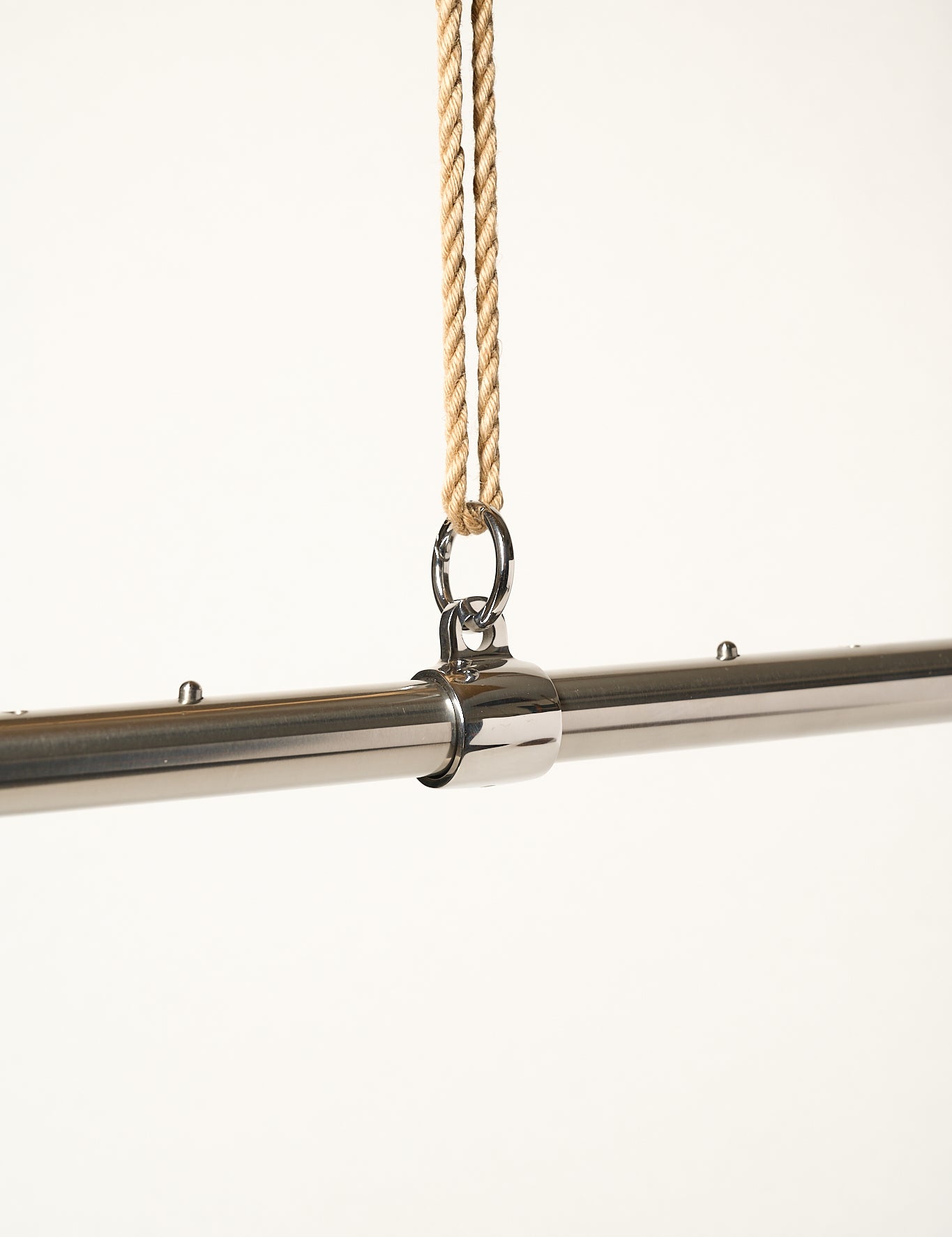 metal adjustable bar attached with o-ring to jute rope