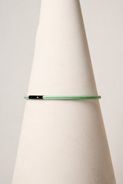 Mint leather necklace with black clasp on white background