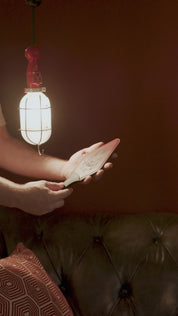 leather shaped strap light on red background hit on hand