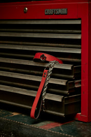 red leather silver hardware leash and necklace choker on craftsman toolbox