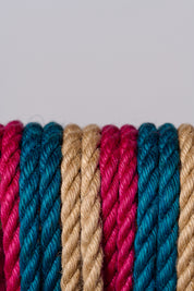 Close-up of multicolored jute ropes on a light gray background